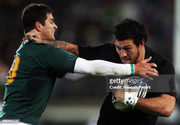 Rene Ranger of the All Blacks fends off Morne Steyn of the Springboks during the Tri-Nations match between the New Zealand All Blacks and South...