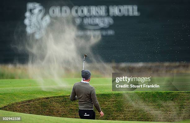 Steven Tiley of England plays a bunker shot on the 16th hole during the completion of the second round of the 139th Open Championship on the Old...