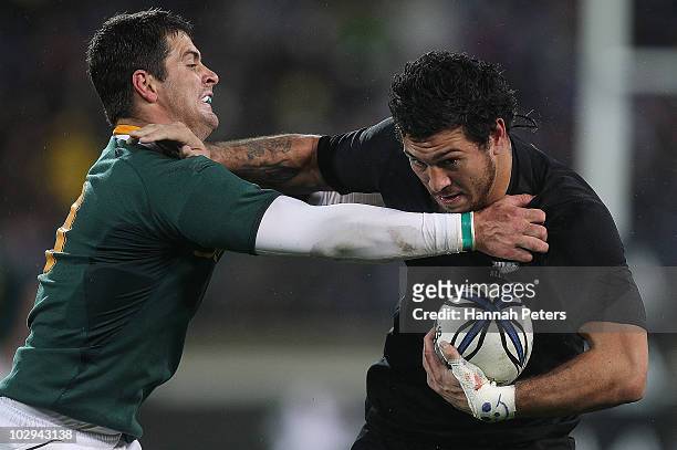 Rene Ranger of the All Blacks fends off Morne Steyn of the Springboks during the Tri-Nations match between the New Zealand All Blacks and South...
