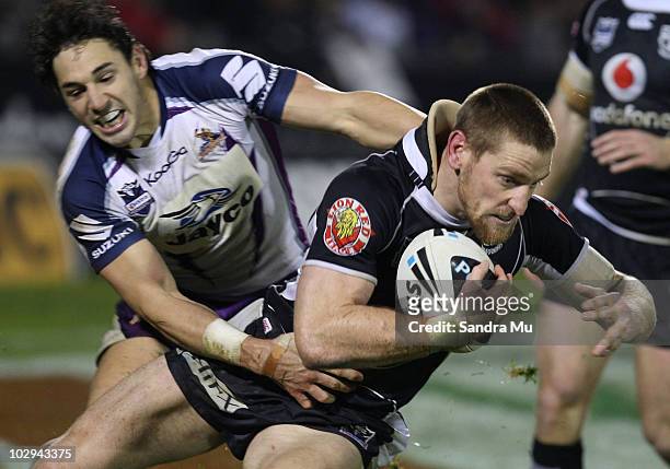 Billy Slater of the Storm tackles Brent Tate of the Warriors during the round 19 NRL match between the Warriors and the Melbourne Storm at Mt Smart...