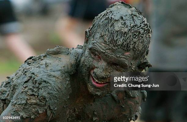 Mud covered particpant looks on during the 13th Annual Boryeong Mud Festival at Daecheon Beach on July 17, 2010 in Boryeong, South Korea. Now in its...