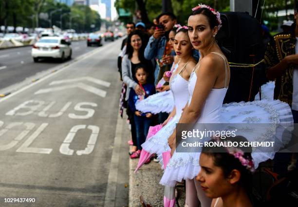 Members of Ardentia dance company wait to perform at Reforma Avenue, in Mexico City, on September 8 during an activity to get classical dance known...