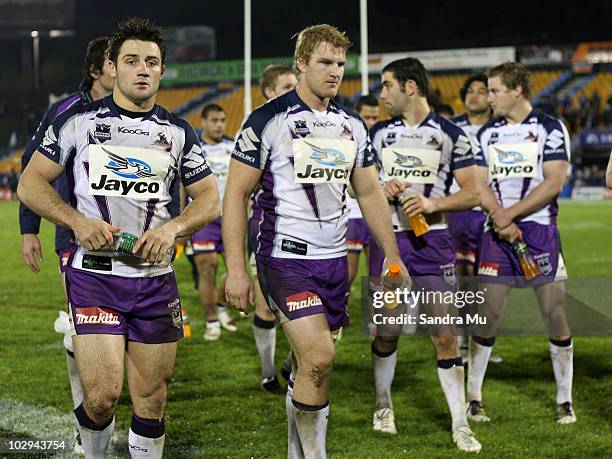 Cooper Cronk and the Storm team walk from the field after the round 19 NRL match between the Warriors and the Melbourne Storm at Mt Smart Stadium on...