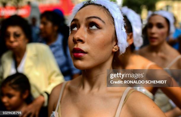 Members of Ardentia dance company wait to perform at Reforma Avenue, in Mexico City, on September 8 during an activity to get classical dance known...