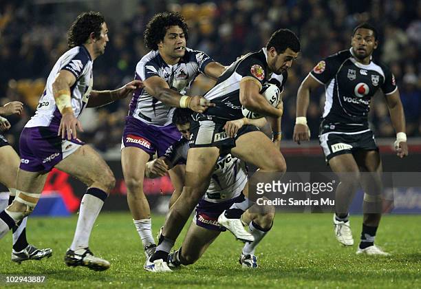 Adam Blair of the Storm holds back Ben Matulino of the Warriors during the round 19 NRL match between the Warriors and the Melbourne Storm at Mt...