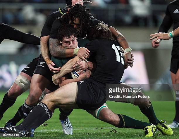 Francois Louw of the Springboks is hit hard by Ma'a Nonu and Conrad Smith of the All Blacks during the Tri-Nations match between the New Zealand All...