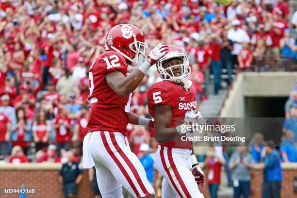 Wide receiver Marquise Brown is congratulated by wide receiver A.D. Miller of the Oklahoma Sooners after scoring a touchdown against the UCLA Bruins...