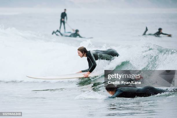 friends surfing at oregon coast - costa de oregon imagens e fotografias de stock