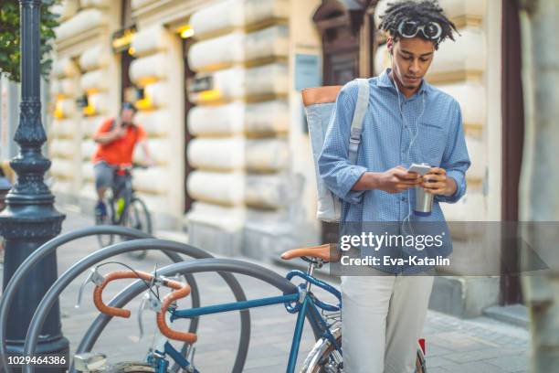 young man is on the move in the city - bike headset stock pictures, royalty-free photos & images