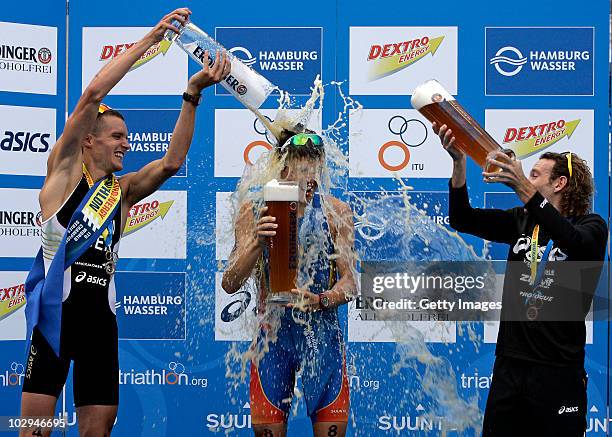 Gold medal winner Javier Gomez of Spain celebrates on the podium with second Jan Frodeno of Germany and third Tim Don of Great Britain during the...