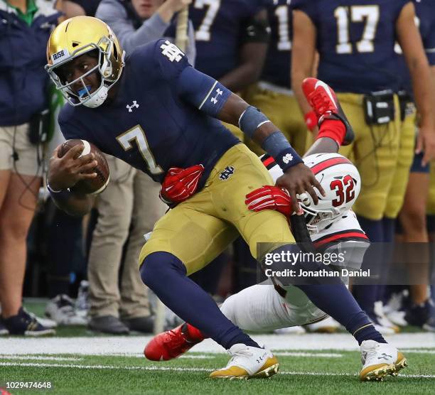 Brandon Wimbush of the Notre Dame Fighting Irish is taken down by Jeremiah Jackson of the Ball State Cardinals at Notre Dame Stadium on September 8,...