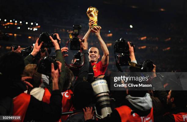 Andres Iniesta of Spain holds the World Cup trophy aloft after the 2010 FIFA World Cup South Africa Final match between Netherlands and Spain at...