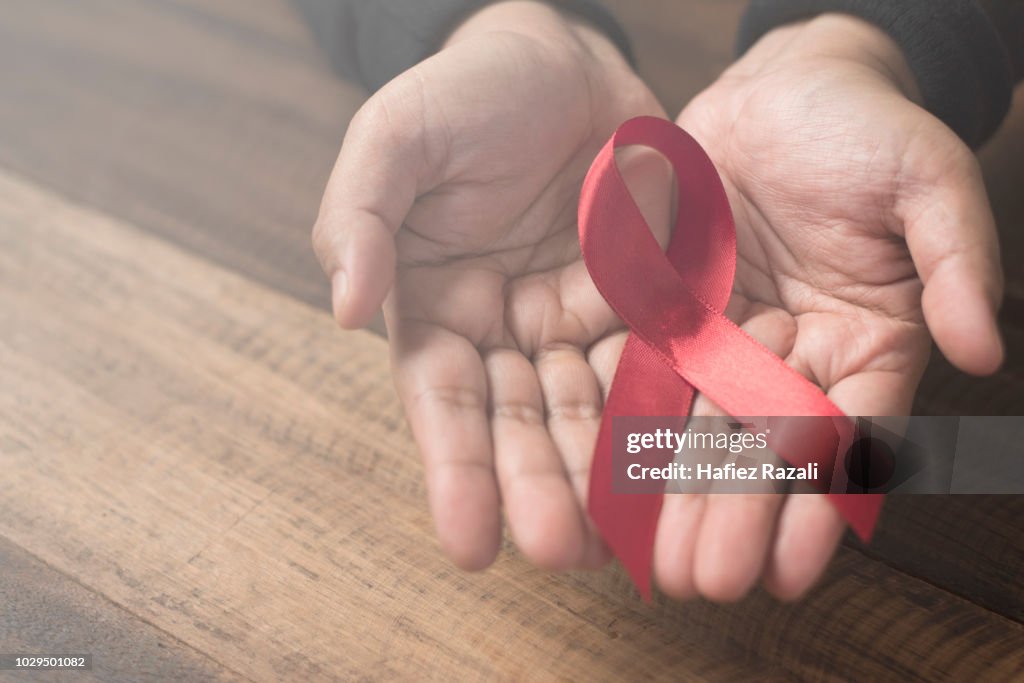 Cropped Hands Holding Aids Awareness Ribbon