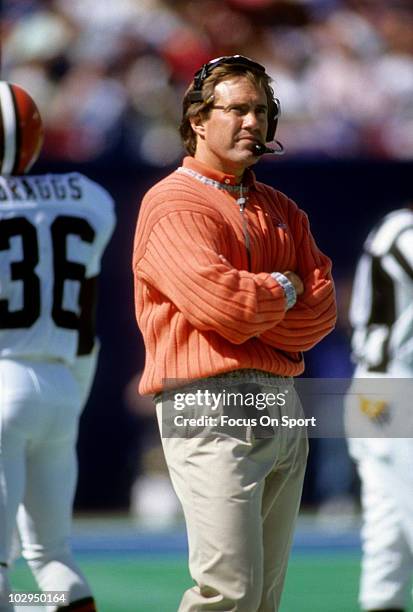 Head coach Bill Belichick of the Cleveland Browns in this portrait watching the action from the sidelines circa 1991 during an NFL football game....