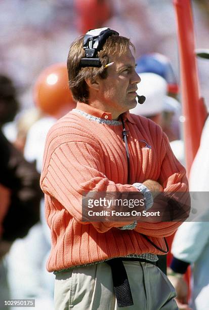 Head coach Bill Belichick of the Cleveland Browns in this portrait watching the action from the sidelines circa 1991 during an NFL football game....