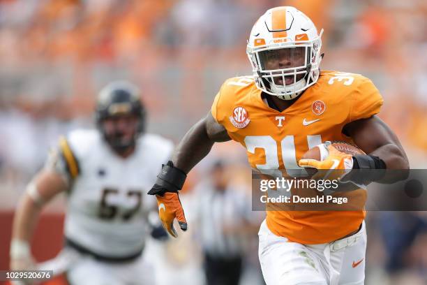 Darrin Kirkland Jr. #34 of the Tennessee Volunteers returns an interception for a touchdown during a game against the East Tennessee State University...