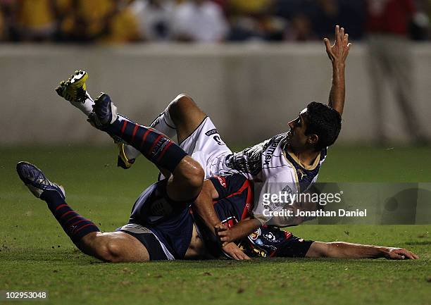 Luis Fuentes of Pumas UNAM lands on Luis Gabriel Rey of Monarcas Morelia after Rey fied a shot on goal during a SuperLiga 2010 match at Toyota Park...