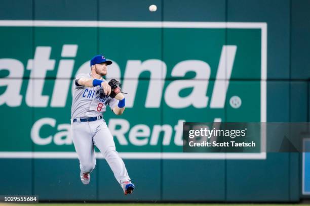 Ian Happ of the Chicago Cubs makes a leaping throw to first against the Washington Nationals during the fourth inning of game two of a doubleheader...