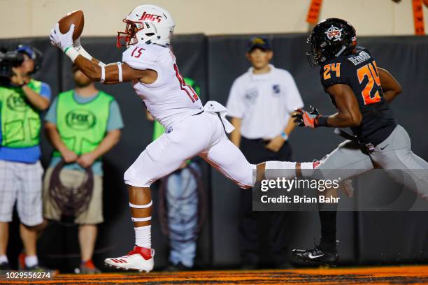 Wide receiver Kawaan Baker of the South Alabama Jaguars pulls down a touchdown against safety Jarrick Bernard of the Oklahoma State Cowboys in the...