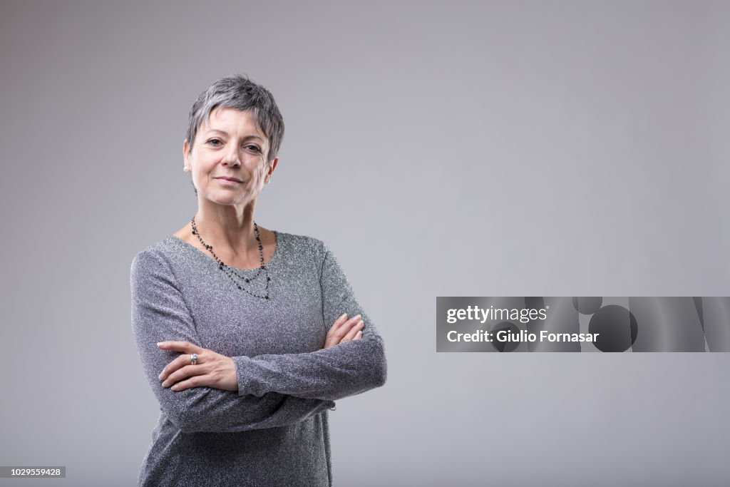 Confident businesswoman with folded arms