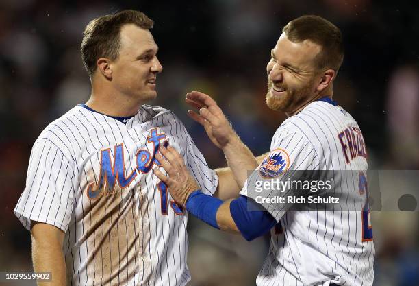 Jay Bruce and Todd Frazier of the New York Mets react between innings against the Philadelphia Phillies during a game at Citi Field on September 8,...