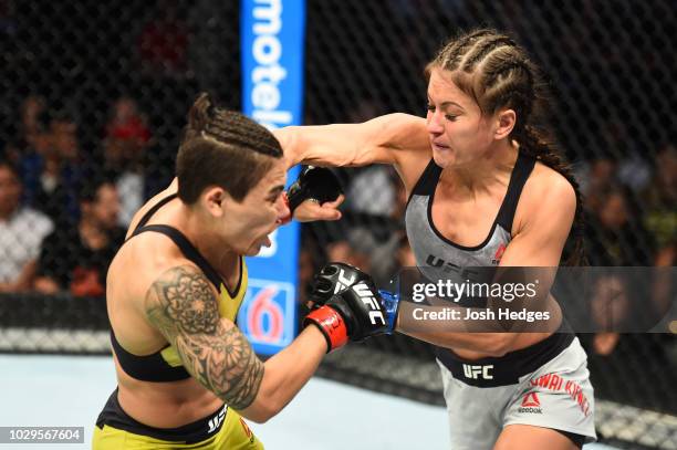 Karolina Kowalkiewicz of Poland punches Jessica Andrade of Brazil in their women's strawweight fight during the UFC 228 event at American Airlines...