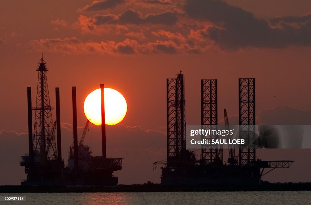 The sun sets behind two under constructi