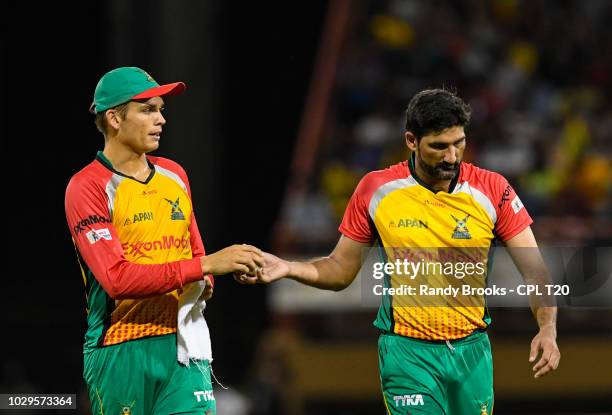 In this handout image provided by CPL T20, Chris Green and Sohail Tanvir of Guyana Amazon Warriors during match 29 of the Hero Caribbean Premier...