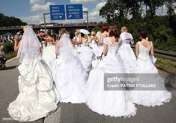 Women wearing wedding dresses take part in the "Still Life" Ruhr 2010 European Capital of Culture festivities with the initiative "100 brides for...