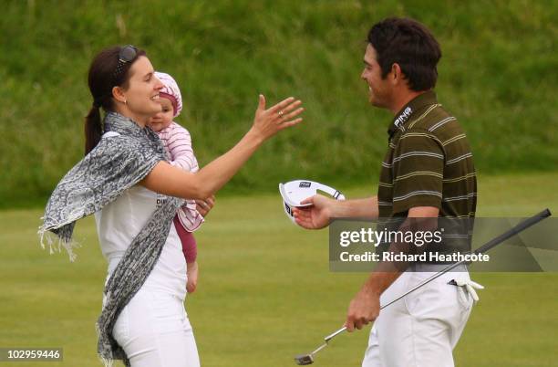 Louis Oosthuizen of South Africa celebrates his seven-stroke victory with his wife Nel-Mare and daughter Jana on the 18th green at the 139th Open...