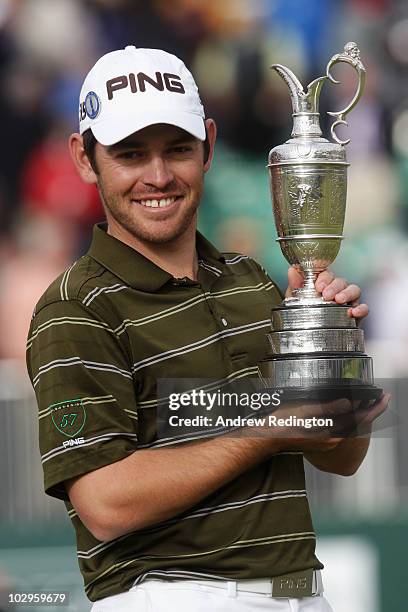 Louis Oosthuizen of South Africa poses with the Claret Jug after his seven-stroke victory at the 139th Open Championship on the Old Course, St...