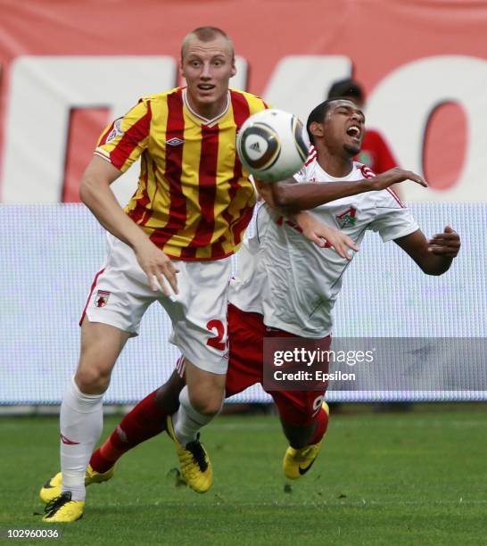 Ivan Ivanov of FC Alania Vladikavkaz challenges for the ball with Maicon of FC Lokomotiv Moscow during the Russian Football League Championship match...