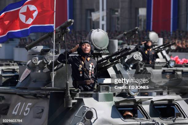 Korean People's Army soldiers stand atop armoured vehicles during a military parade on Kim Il Sung square in Pyongyang on September 9, 2018. - North...