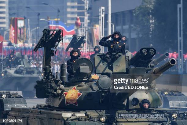 Korean People's Army soldiers stand atop armoured vehicles during a military parade on Kim Il Sung square in Pyongyang on September 9, 2018. North...
