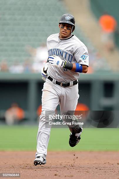 Yunel Escobar of the Toronto Blue Jays rounds the bases after hitting a grand slam home run in the second inning against the Baltimore Orioles at...