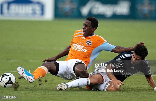 Lovel Palmer of the Houston Dynamo is tackled from behind by Marcelo Saragosa of Chivas USA in the first half of SuperLiga action at Robertson...