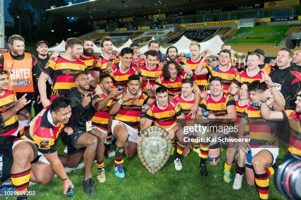 Captain Dwayne Sweeney of Waikato and his team mates pose with the Ranfurly Shield after their win in the round four Mitre 10 Cup Ranfurly Shield...