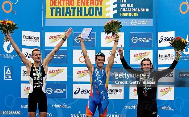 Gold medal winner Javier Gomez of Spain celebrates on the podium with second Jan Frodeno of Germany and third Tim Don of Great Britain during the...