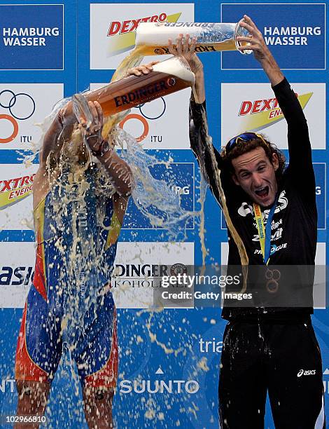 Gold medal winner Javier Gomez of Spain celebrates on the podium with third Tim Don of Great Britain during the Men's Dextro Energy Triathlon ITU...