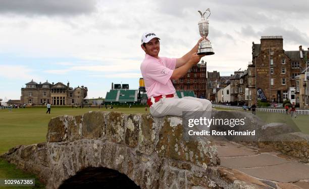 Open Champion Louis Oosthuizen of South Africa poses with the Claret Jug on the Swilken bridge on July 19, 2010 in St Andrews, Scotland