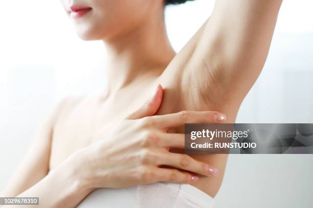 woman touching armpit - armpit stock pictures, royalty-free photos & images