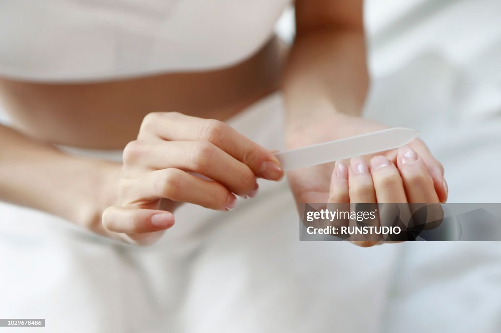 Woman using nail file