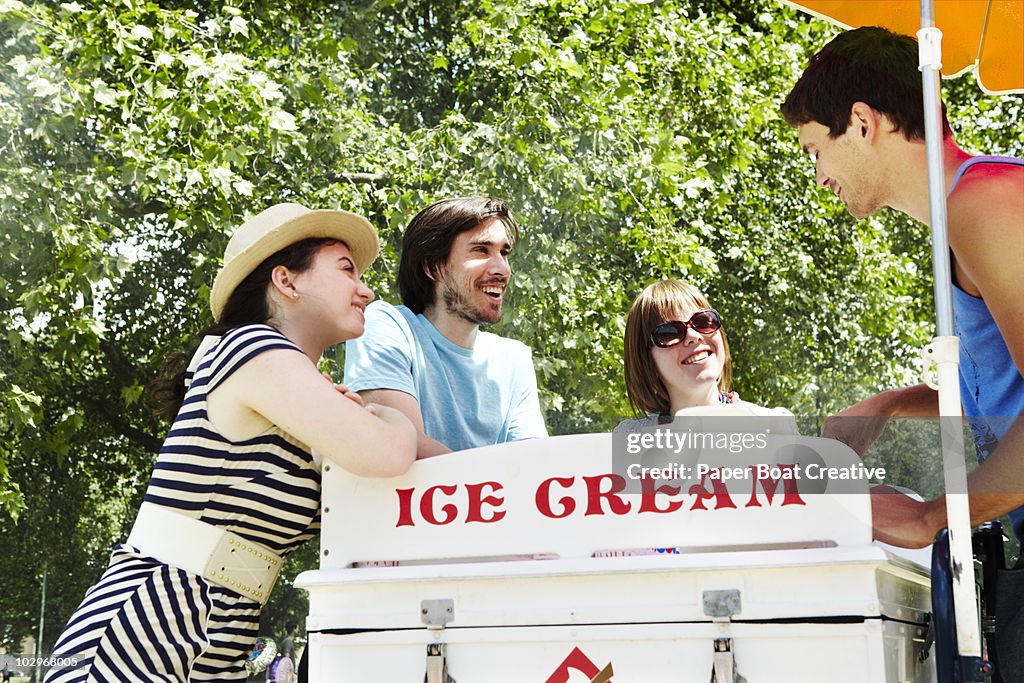 Friends buying ice cream from the vendor