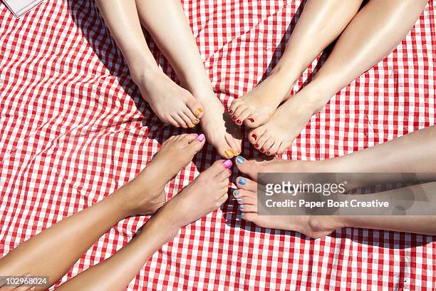 girls comparing pedicure nail polish colours - barefeet stock-fotos und bilder