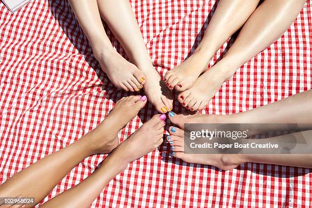 girls comparing pedicure nail polish colours - nail polish stockfoto's en -beelden