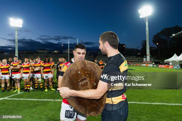 Captain Mitchell Crosswell of Taranaki hands over the Ranfurly Shield to captain Dwayne Sweeney of Waikato following the round four Mitre 10 Cup...