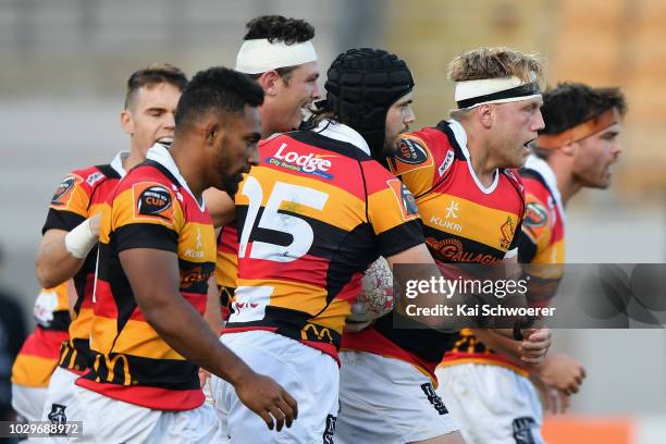 James Tucker of Waikato is congratulated by team mates after scoring a try during the round four Mitre 10 Cup Ranfurly Shield match between Taranaki...