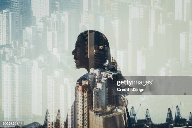 double exposure of confidence young woman over cityscape - mehrfachbelichtung stock-fotos und bilder