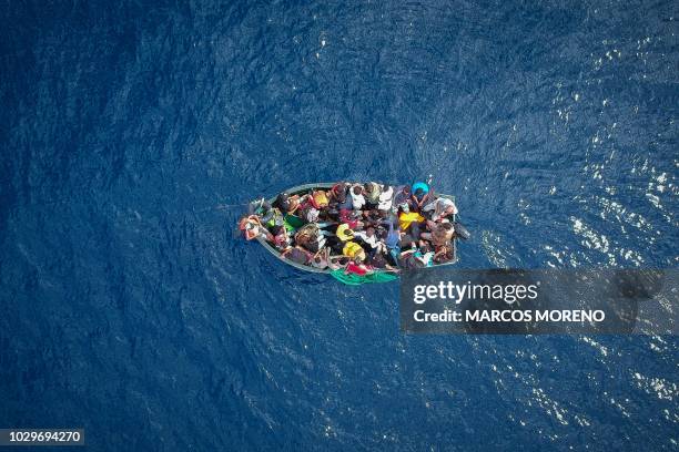 An aerial photo shows a boat carrying migrants stranded in the Strait of Gibraltar before being rescued by the Spanish Guardia Civil and the...