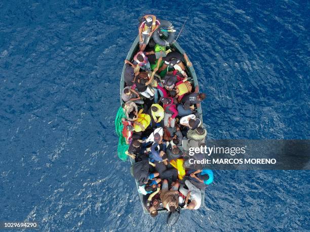 An aerial photo shows a boat carrying migrants stranded in the Strait of Gibraltar before being rescued by the Spanish Guardia Civil and the...